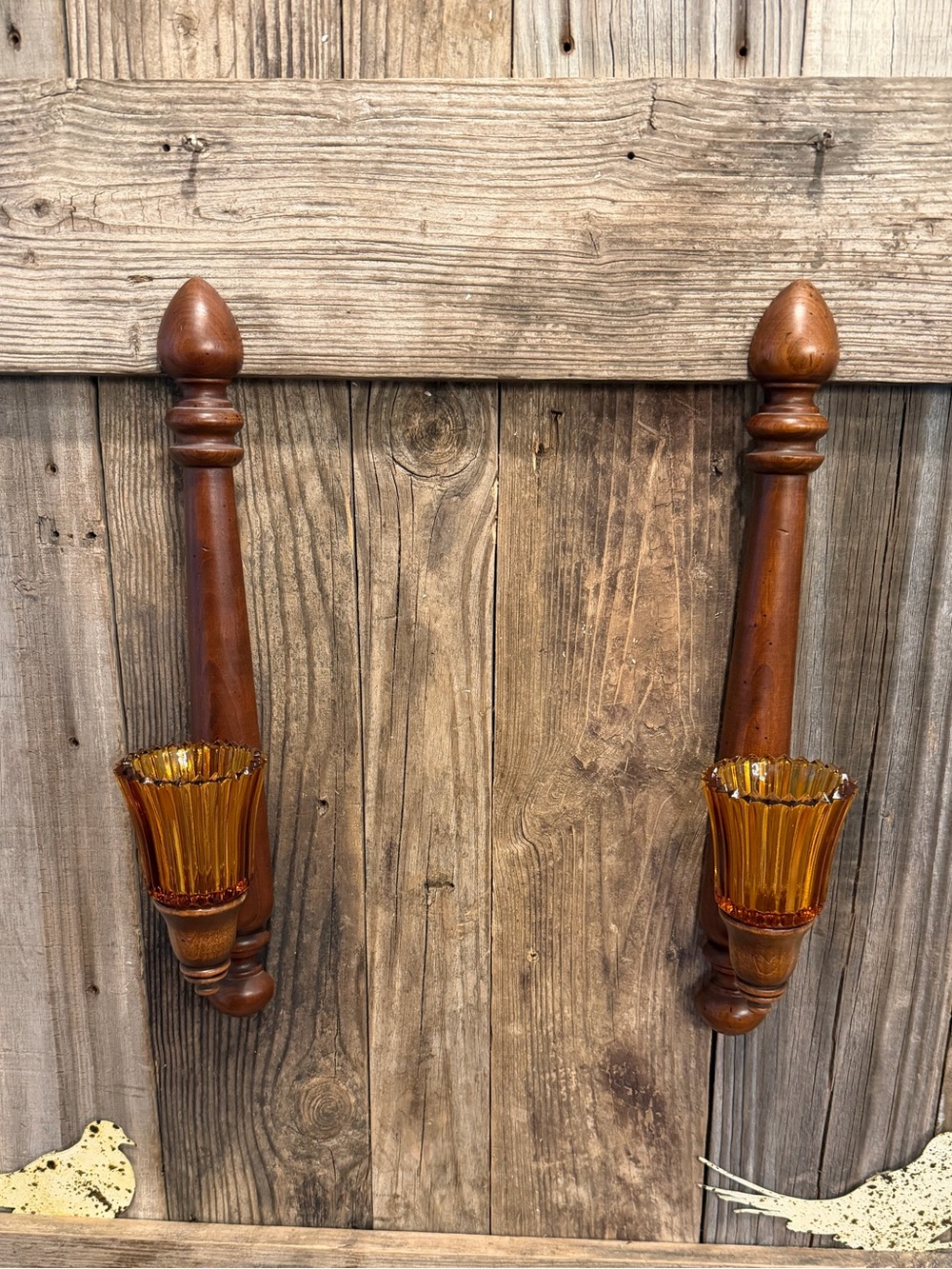 Pair of vintage turned-wood candle wall sconces with ribbed amber glass
